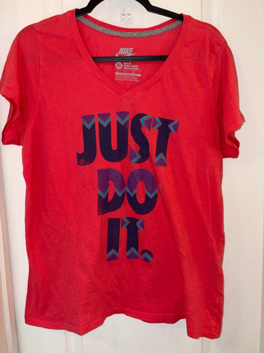 Nike Pink V‑Neck Tee with Navy and Teal Graphic